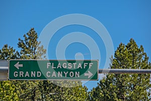 Flagstaff and Grand Canyon Road Sign in the Arizona Pine Forest. Flagstaff, Arizona