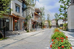 Flagstone-paved street between archaised Chinese buildings on sunny day