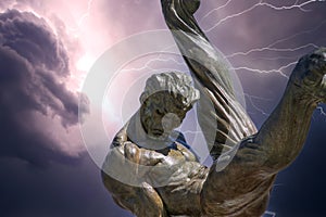 The Flair Olympic Statue in Georgia International Plaza with storm clouds and lightning at the Georgia World Congress Center