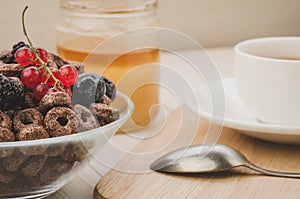 flakes with berries, tea and honey/flakes with berries, tea and honey on a wooden background. Selective fokus