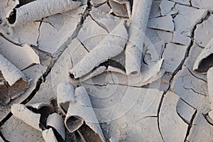 Flakes of dried mud as a background. Dry barren soil texture