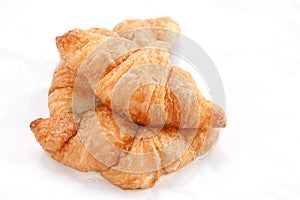 Flaky croissants on white background.