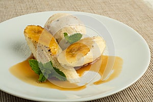Flambe Banana with butter rum ice cream with caramel sauce photo