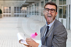 Flamboyant businessman taking notes with a cute pink pen