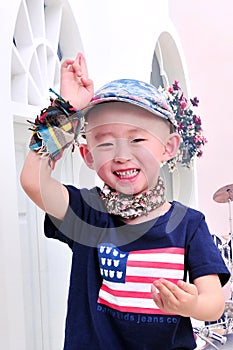 A flamboyant little boy wearing an American flag.