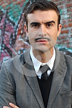 Flamboyant retro man with mustache over urban alley way city with graffiti background