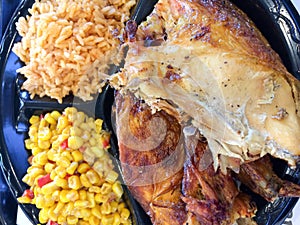Flame broiled bbq chicken with rice and corn