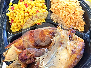 Flame broiled bbq chicken with rice and corn