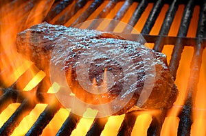 Flame broiled steak on a grill
