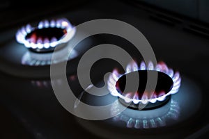 The flame of a burning gas fire on a black background. Burning gas burner in the darkness