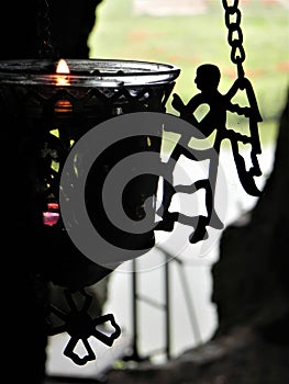 The flame of a candle with an angel with its wings open