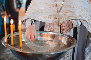 the flame of church candles at the ceremony of baptism of a child in the church