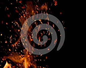 Flame of fire with sparks on a black background