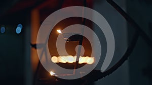 Flame flickers on oil lamps lined in Buddhist temple for evening prayers. Peaceful ambiance as lights burn in spiritual