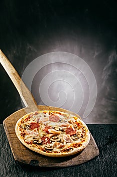 Flame grilled ham and pepperoni pizza photo