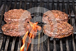 Flame-grilled hamburgers on the grill