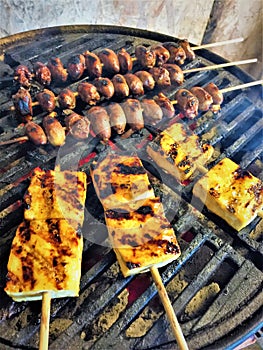 Flame Grilling Chicken Hearts and Pineapple