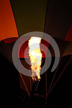 Flame heating a hot air balloon at night