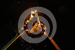 Flame on a homemade torch, fire on the background of night streets, peaceful actions with torches