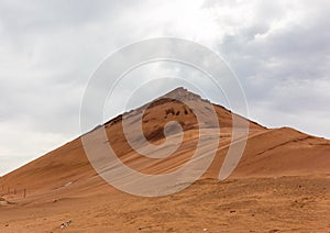 The flame mountain in the Turpan area of Xinjiang, the red mountain body, the grass is not born photo