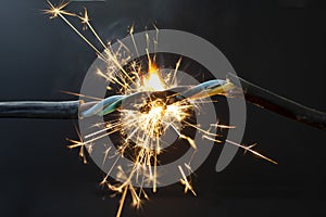 flame smoke and sparks on an electrical cable, fire hazard concept