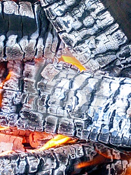 Flame on the wood, with ash