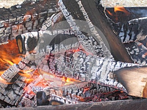 Flame on the wood, with ash