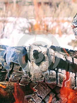 Flame on the wood, with ash