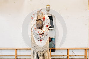 Flamenco dancer with her back to the stage with Manila shawl