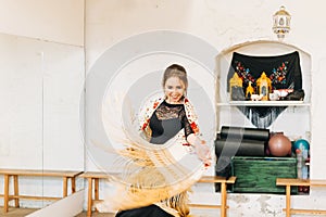 flamenco dancer smiling and moving the manila shawl