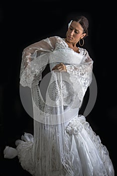 Flamenco dancer with white dress and hands crossed