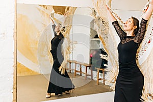 Flamenco female dancer with shawl training on a class