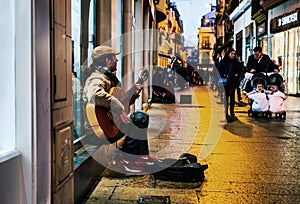 Flamenco guitarist in the streets of sevilla at night.