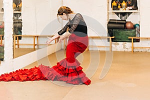 Flamenco woman dancer on a pose in the dance studio