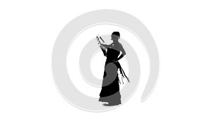Flamenco. Woman is dancing with a manton . White background. Silhouette. Slow motion