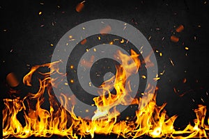 Flame with sparks in front of black background