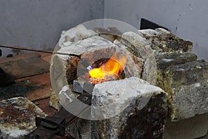 Flames burn brightly as heat is applied to silver, it is going to be melted down and used for casting