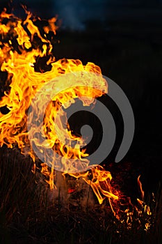 The flames burned the hay in the night fields.