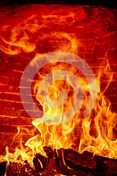 Flames burning inside a wood oven. Flames inside the wood-fired pizza oven.Flame produced by the combustion of wood inside an