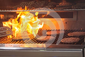 Flames Charbroil Hamburgers Cooking On A Grill photo