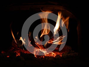 The flames of the fire in the fireplace