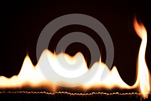 Flames and fire in front of black, lots of matches burning