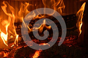 Logs burning in the hearth of a fireplace