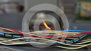 Flames, sparks, smoke between electrical cables. Short circuit in twisted wires