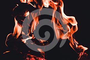 Flames and wood burning in a firepit