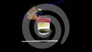Flaming B52 Cocktail Alcohol Shot On Fire in Night Club Close Up