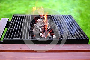 Flaming charcoal and BBBQ Grill photo
