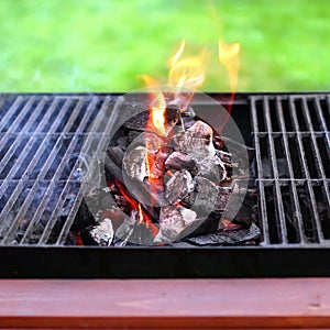 Flaming charcoal and BBBQ Grill photo
