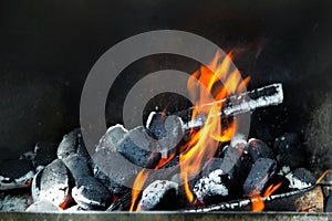 Flaming charcoal grill with open fire. Concept of summer grilling