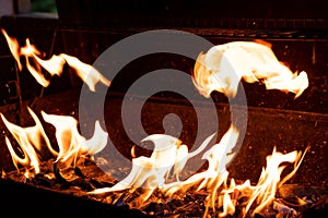 Flaming Empty Hot Barbecue Charcoal Grill With Glowing Coals On Black Background.Flame dance, barbecue on an open fire